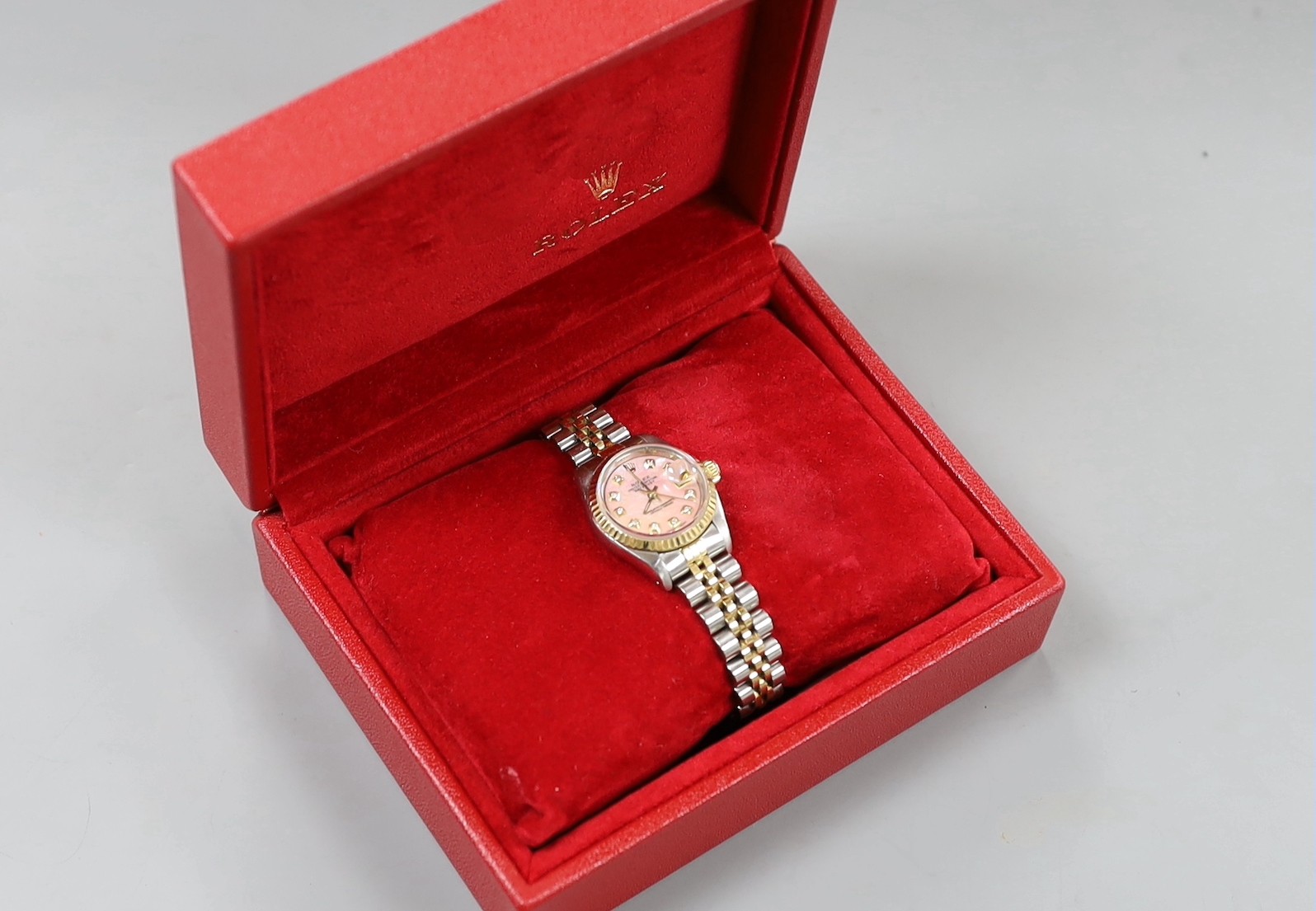 A lady's 2015 steel and gold Rolex Oyster Perpetual Datejust wrist watch, with pink mother of pearl dial and diamond set markers, model no. 69173, serial no. R401799, case diameter 26mm, with box and certificate.